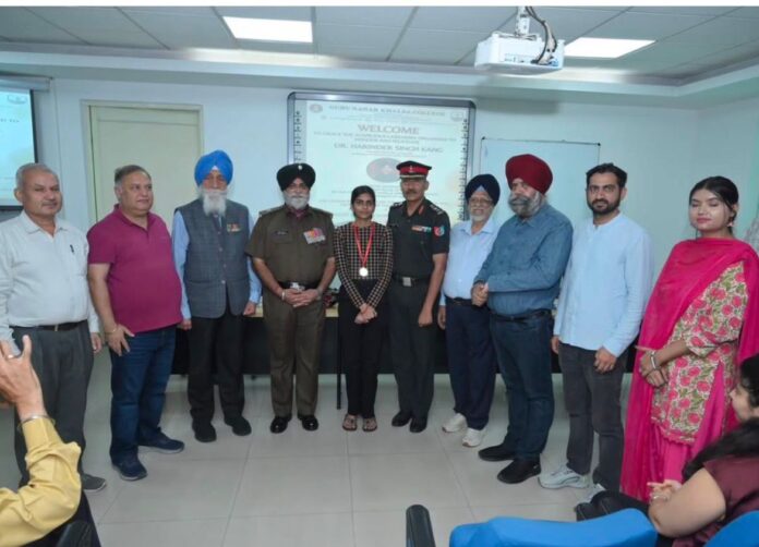 GNK College Yamunanagar student Shivani being honoured with a gold medal for academic excellence.