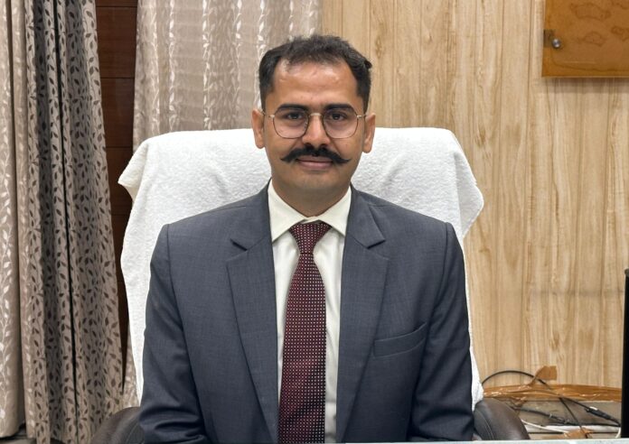 Deputy Commissioner Vishram Kumar Meena highlighting Haryana government welfare schemes in Kurukshetra.