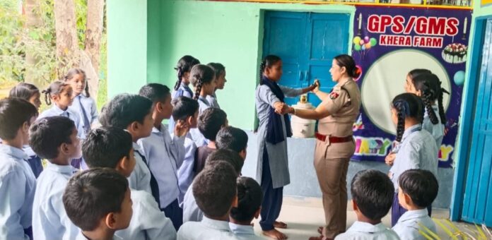 Yamunanagar Police Safe City Team conducts a child safety awareness session at Government Middle School, Khera Farm, explaining good touch and bad touch, self-defence and the 112 emergency helpline.