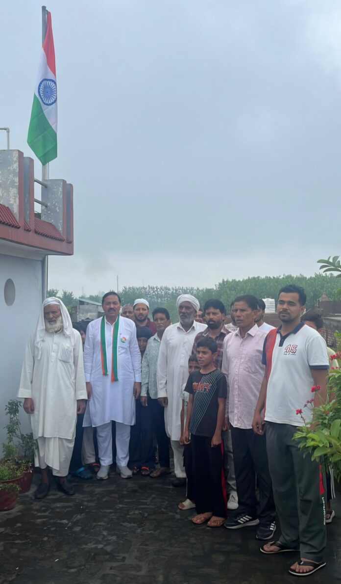 Rana As Mohammad Mandoli and villagers participate in a Tricolour hoisting ceremony on Independence Day.