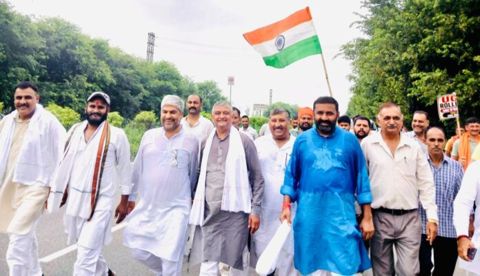 Kapil Pandit walking alongside participants during the padyatra from Panipat to Chandigarh over education-related demands.