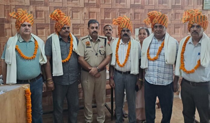 ASP Ashish Chaudhary with retiring police personnel during a farewell ceremony at District Police Lines Jagadhri.
