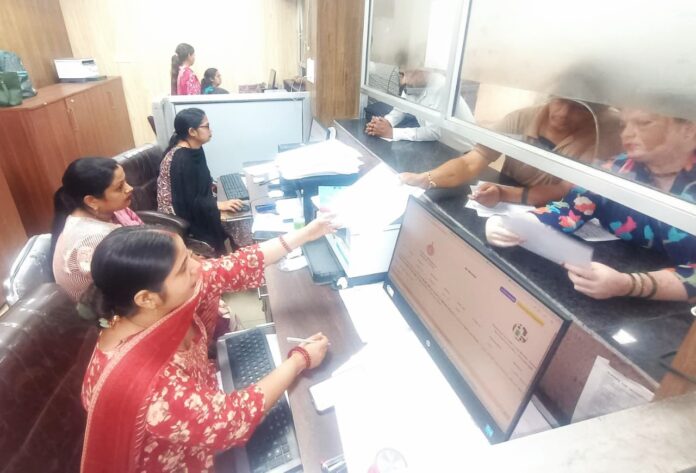 Taxpayers standing in queues at a Yamunanagar Municipal Corporation Citizen Facilitation Centre to deposit property tax.