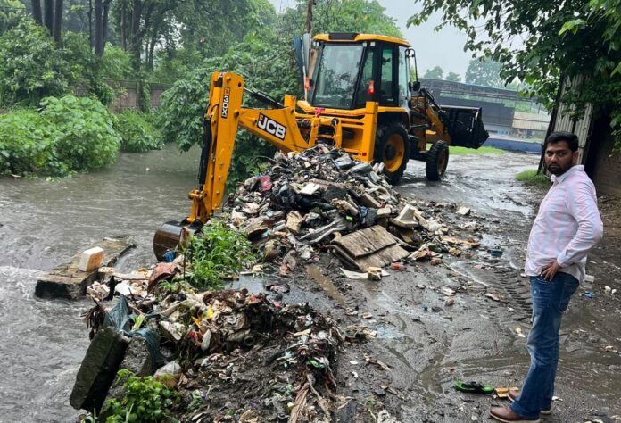Municipal Corporation workers carry out water drainage work during rain in Yamunanagar