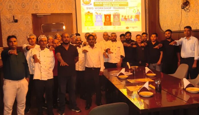 Municipal Corporation Yamunanagar-Jagadhri Swachh Bharat Mission team conducting a workshop on four-bin waste segregation and Solid Waste Management Rules 2026 at a Model Town restaurant.