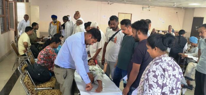 Beneficiaries undergoing assessment for assistive devices at a District Red Cross Society camp in Yamunanagar