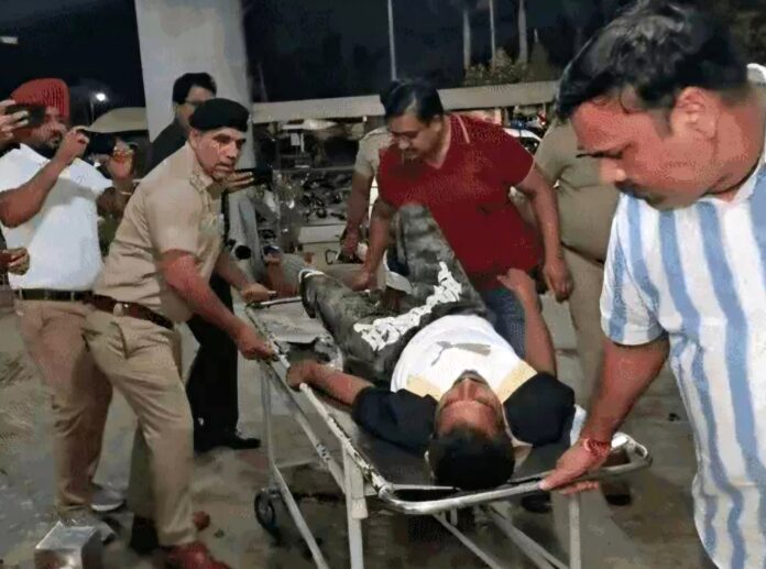 Police personnel escort injured Harbhajan Singh on a stretcher after the shooting outside Jack Fitness Gym in Model Town, Yamunanagar