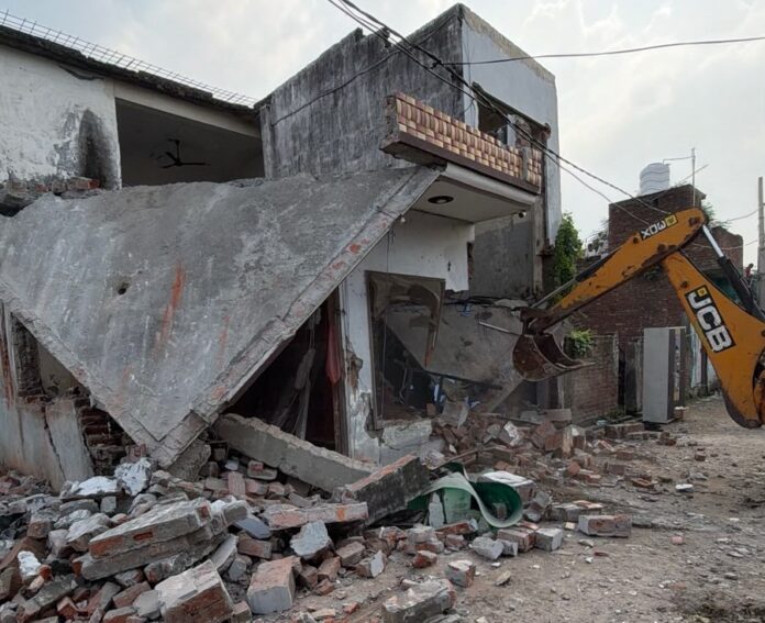 Municipal Corporation team demolishing an unauthorised two-storey house in Khadda Colony Yamunanagar