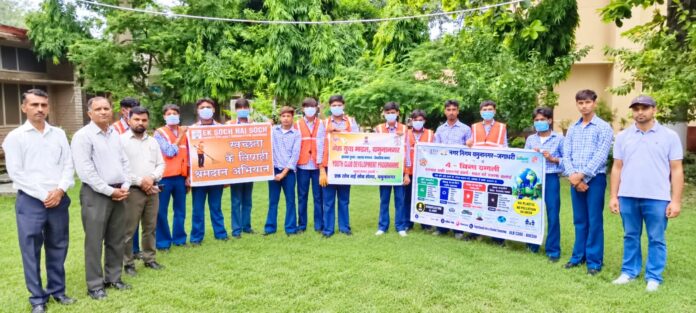 Students and teachers participating in a cleanliness drive at a government school in Jagadhri