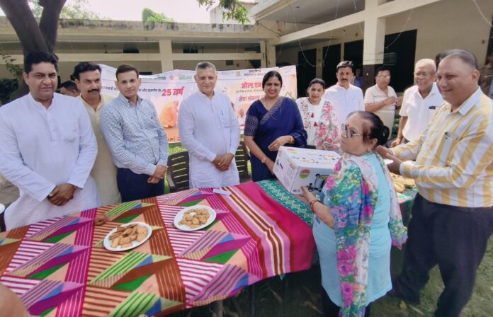 Yamunanagar Mayor Suman Bahamani and civic representatives present gifts to an elderly resident at a Jagadhri old-age home