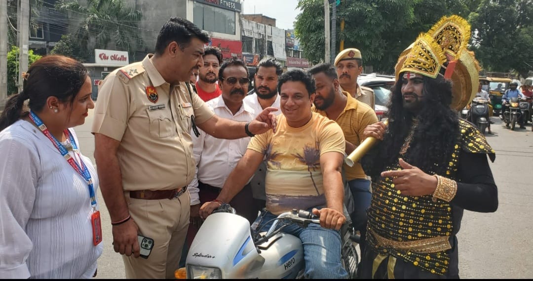 Police officer with motorcycle rider during helmet awareness campaign featuring Yamaraj