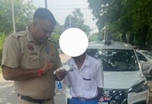 Yamunanagar Traffic Police Impound 20 Vehicles in Special School-Zone Safety Drive Yamunanagar Traffic Police officer checks a vehicle during a special traffic safety drive around schools