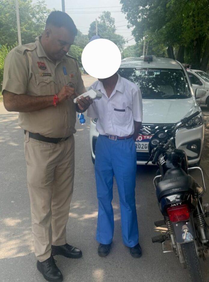Yamunanagar Traffic Police officer checks a vehicle during a special traffic safety drive around schools